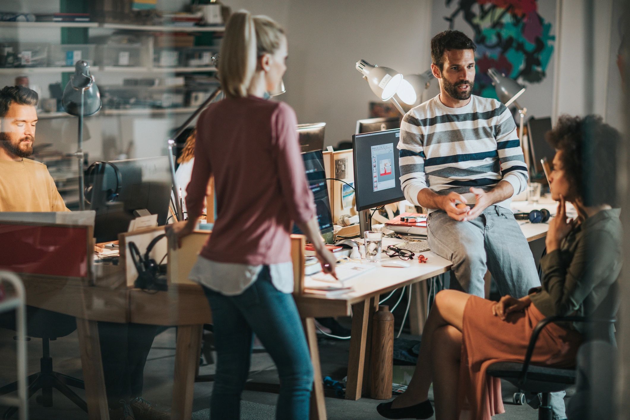 Team of young creatives talking in an office