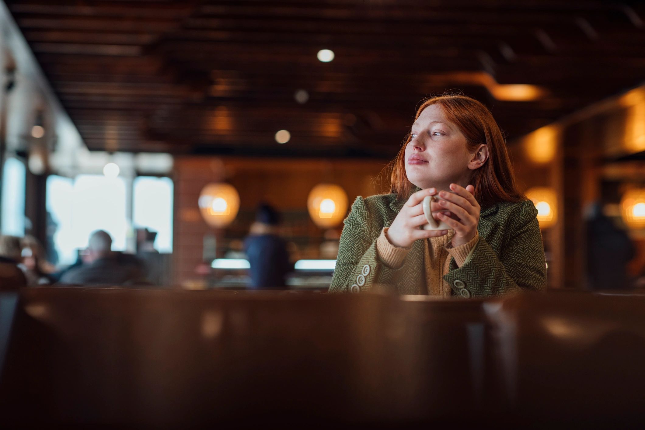 Woman enjoying a quiet coffee moment by the window