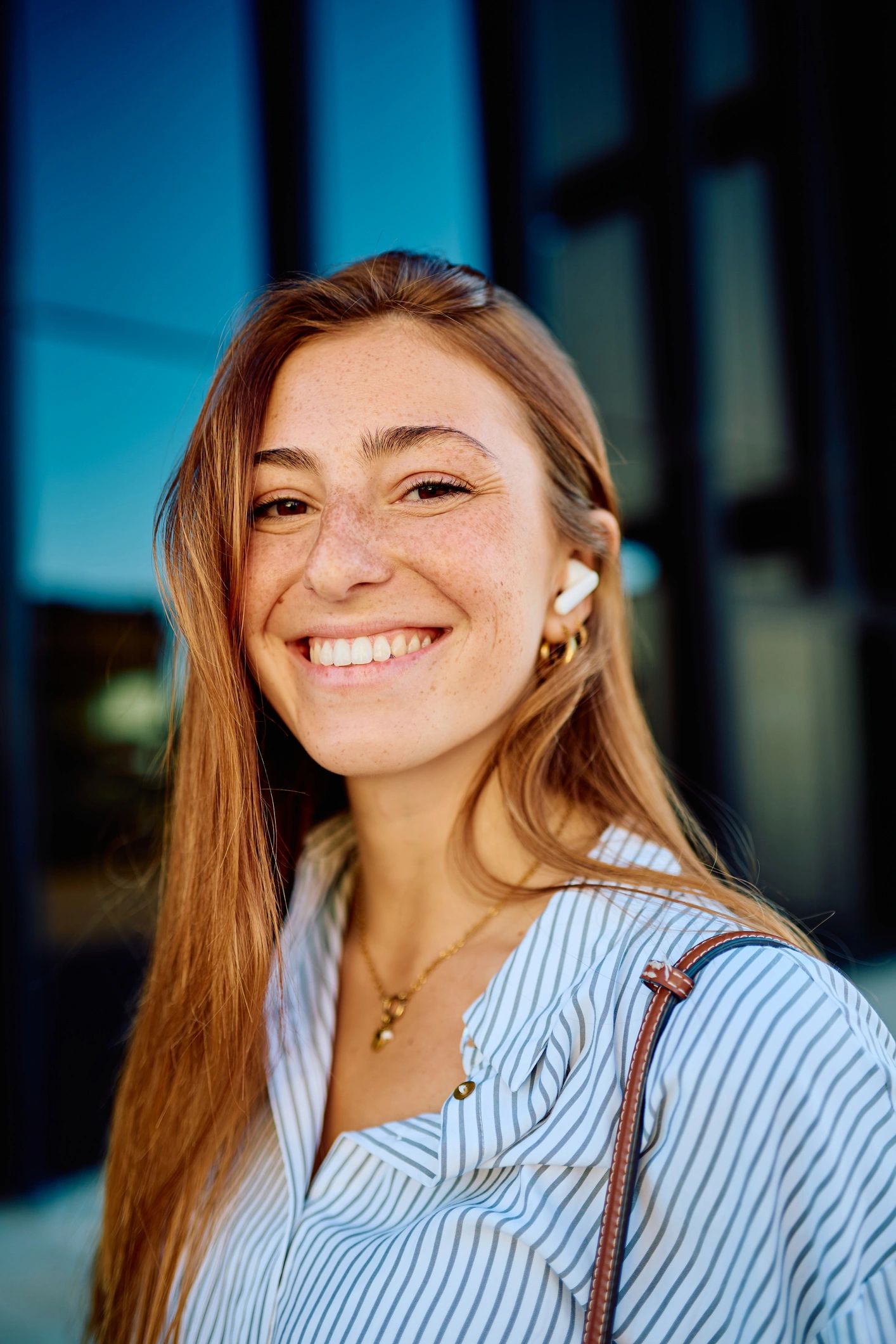 Young woman with freckles smiling